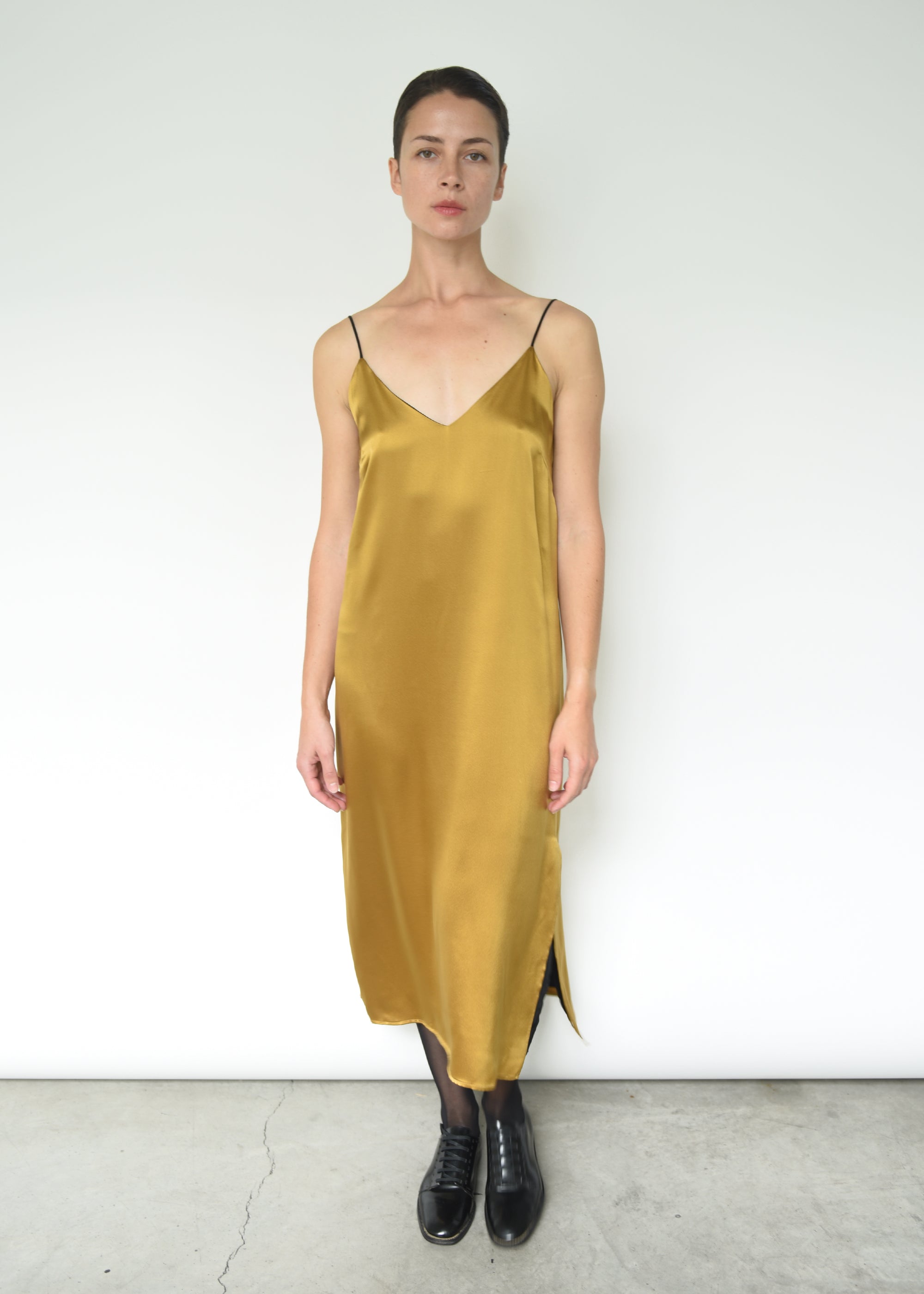 Detail of the corded straps on the brass silk charmeuse Kamperett Sade Slip Dress.