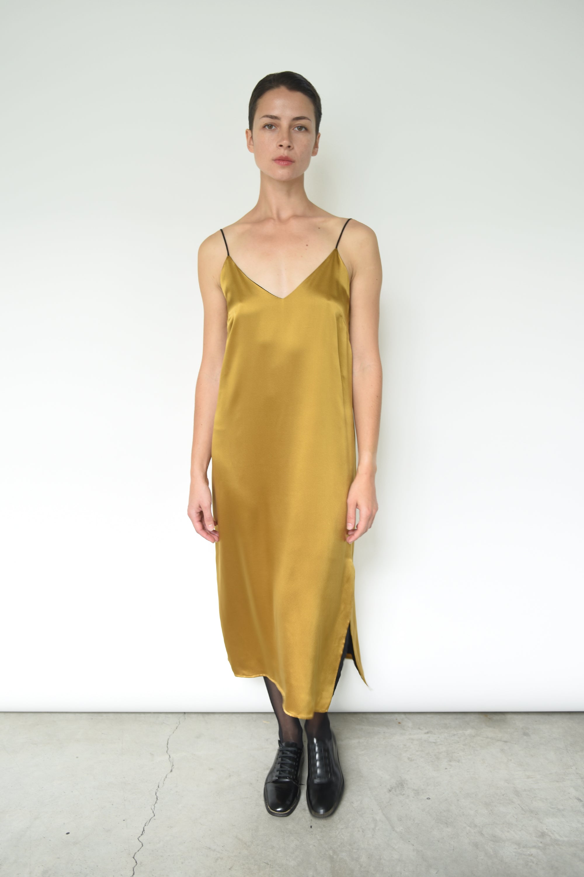 Detail of the corded straps on the brass silk charmeuse Kamperett Sade Slip Dress.