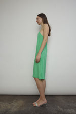 Side view of the celadon silk charmeuse Kamperett Short Slip with straight-cut neckline.