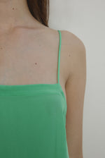 Detail view of the celadon silk charmeuse Kamperett Short Slip showing the fixed spaghetti straps.