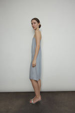 Side view of the powder blue silk charmeuse Kamperett Short Slip with straight-cut neckline.