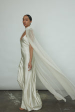 Back motion shot of the ivory silk chiffon Kamperett Choker Cape showing the sweeping veil drape.
