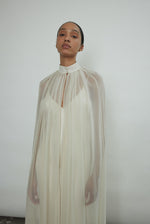 Detail of the self-button collar closure on the ivory silk chiffon Kamperett Choker Cape.
