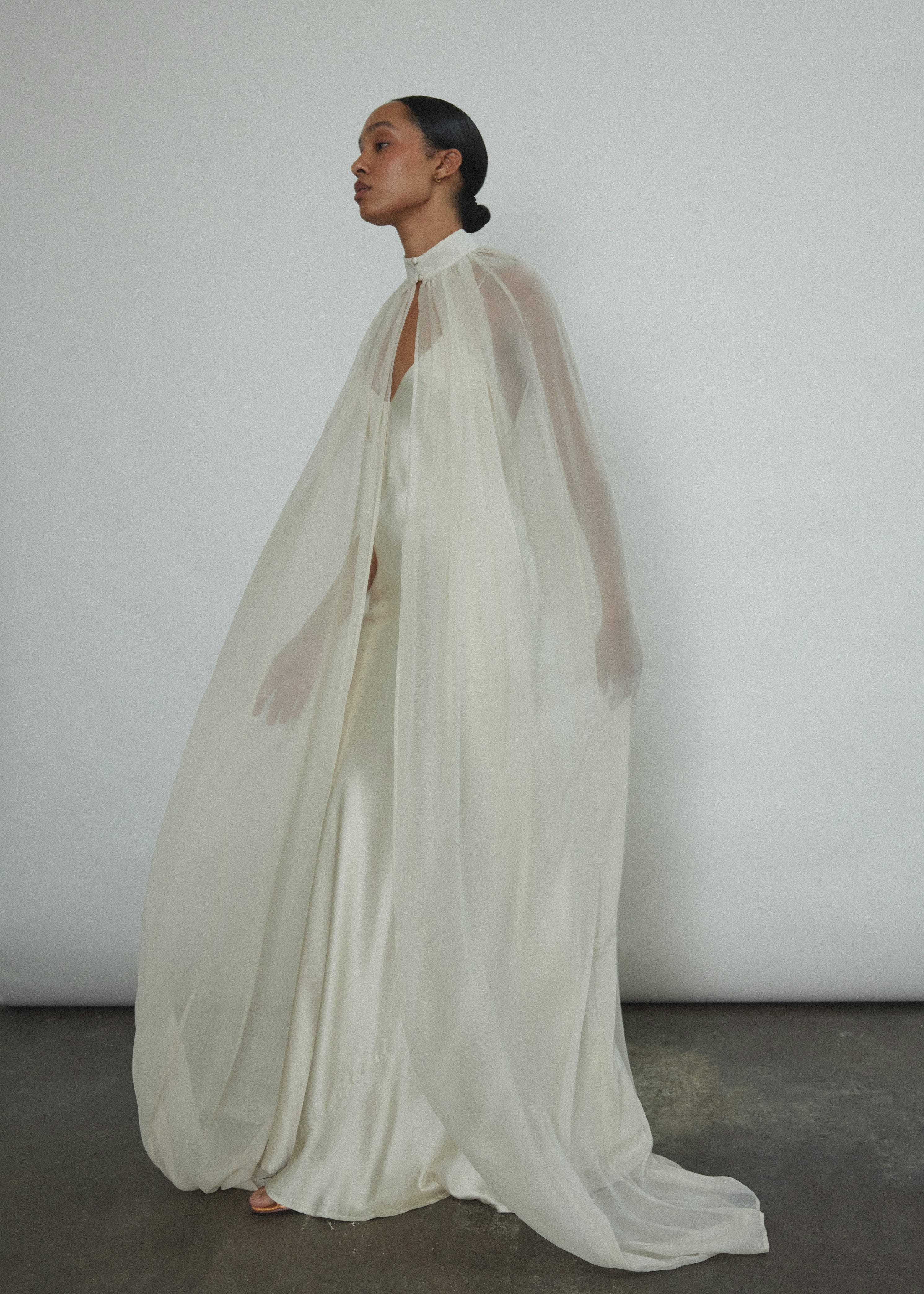 Editorial image of a bride wearing the ivory silk chiffon Kamperett Choker Cape.