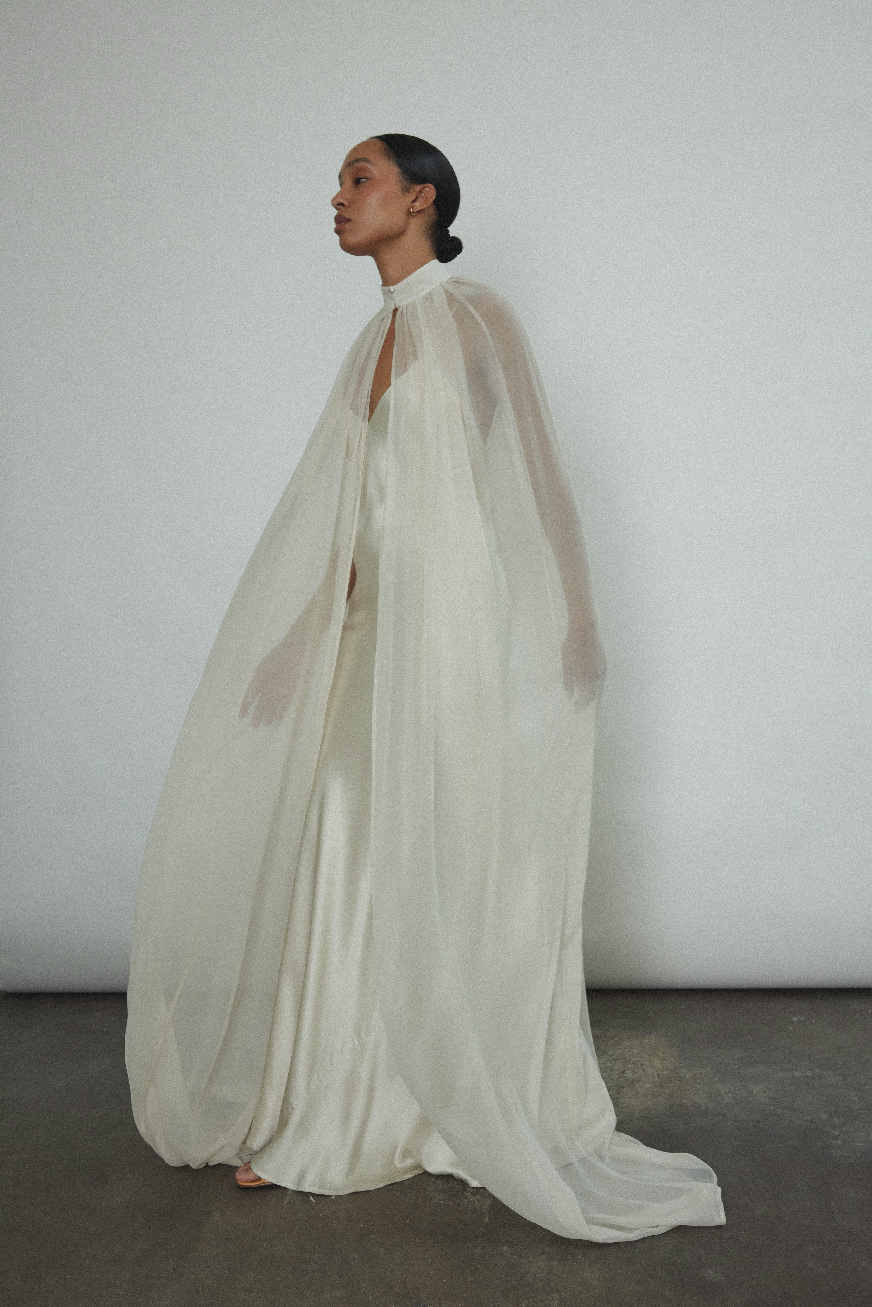 Editorial image of a bride wearing the ivory silk chiffon Kamperett Choker Cape.