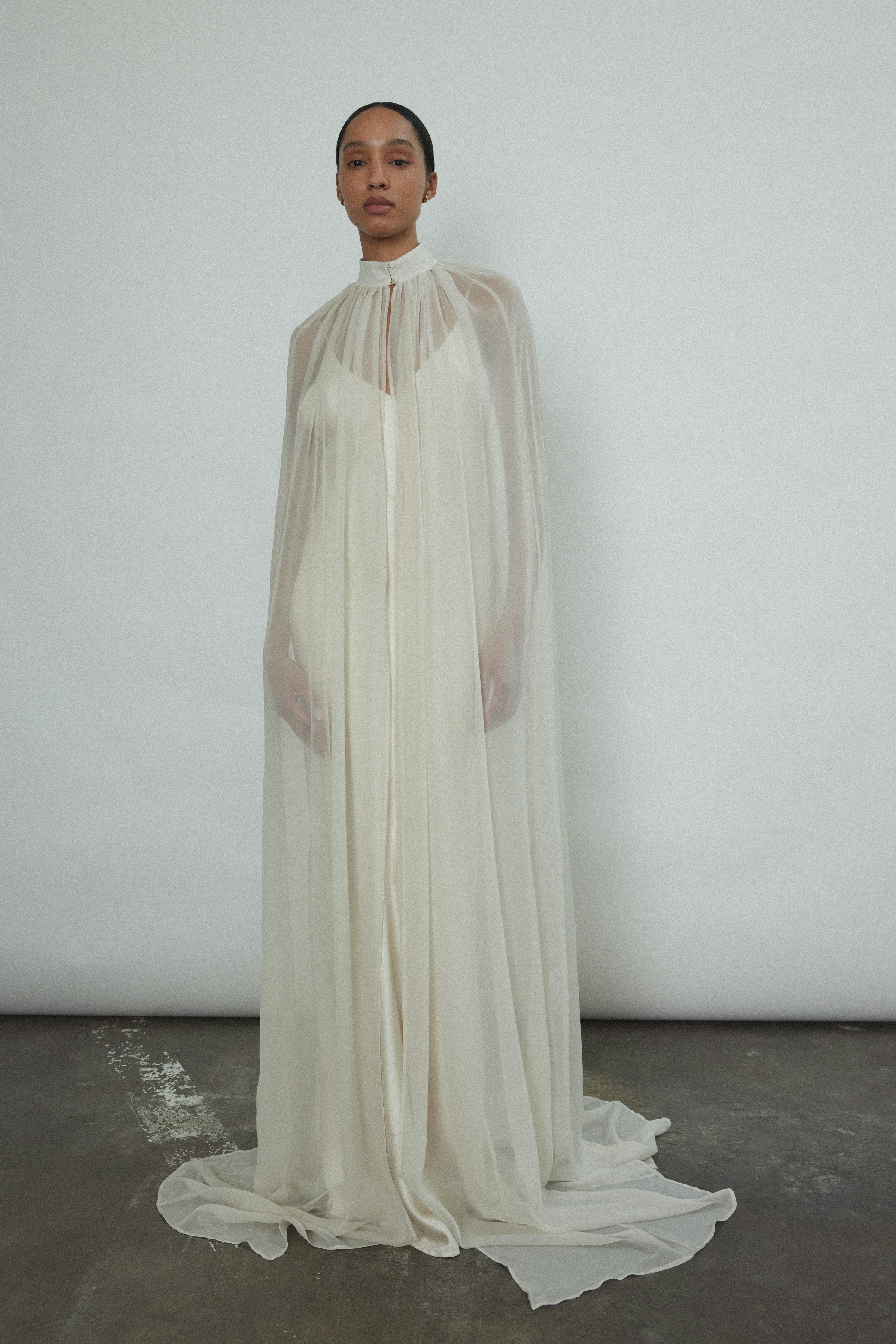 Editorial portrait of a bride in the ivory silk chiffon Kamperett Choker Cape.