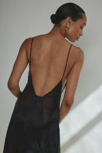Editorial image of the black silk charmeuse Kamperett Simone Slip Dress.