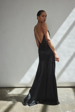 Side view of the black silk charmeuse Kamperett Simone Slip Dress showing the corded spaghetti straps.