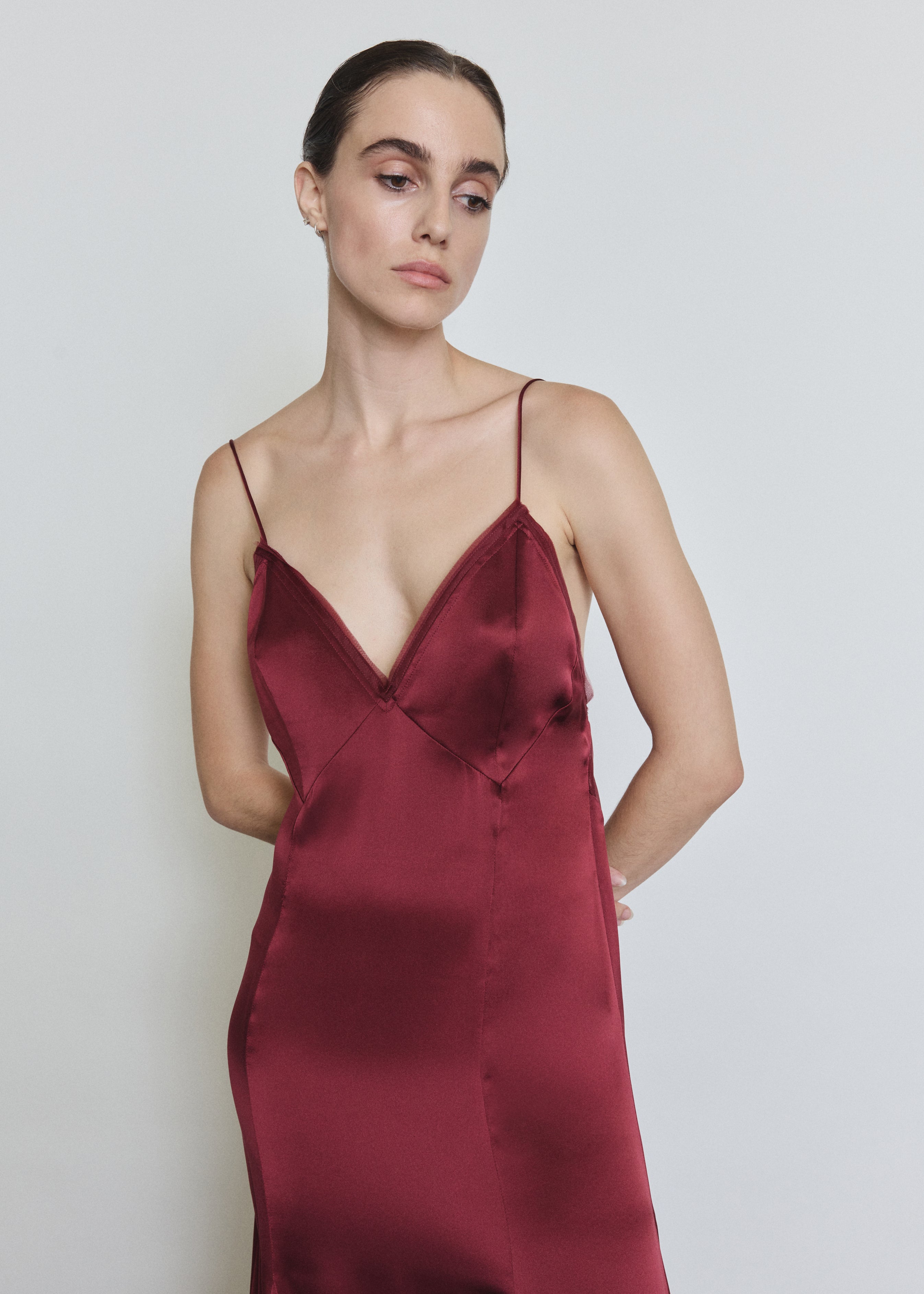 Detail of the bordeaux Kamperett Simone Slip Dress showing the sheer organza back panel and corded strap construction.