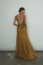 Editorial image of the brass silk charmeuse Kamperett Simone Slip Dress.
