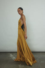 Detail of the sheer diamond-shaped panels on the brass silk charmeuse Kamperett Simone Slip Dress.