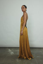 Side view of the brass silk charmeuse Kamperett Simone Slip Dress.