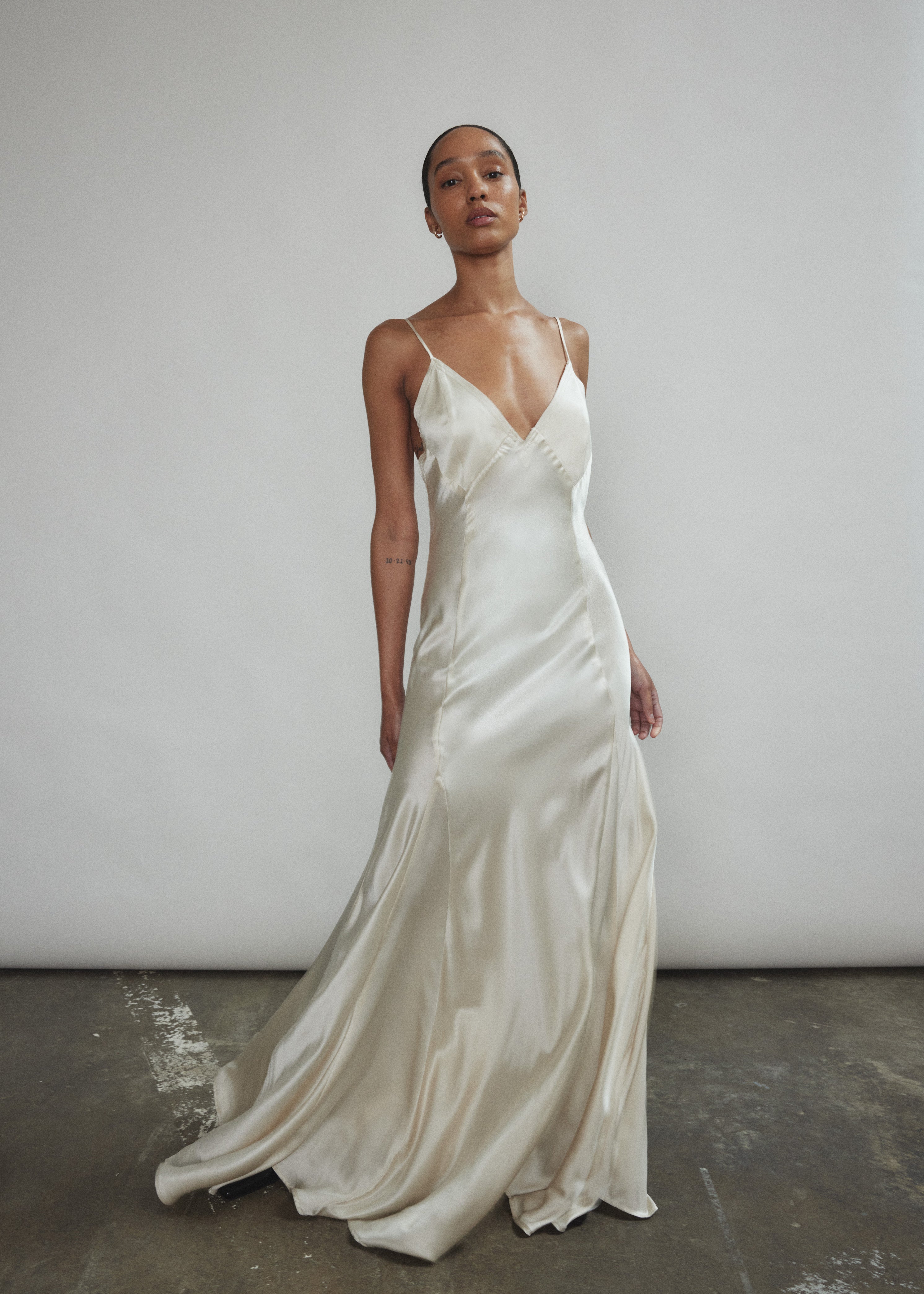 Detail of the sheer diamond-shaped panels on the ivory silk charmeuse Kamperett Simone Slip Dress.