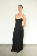Angled view of the black silk charmeuse Kamperett Sloan Slip with corded straps.