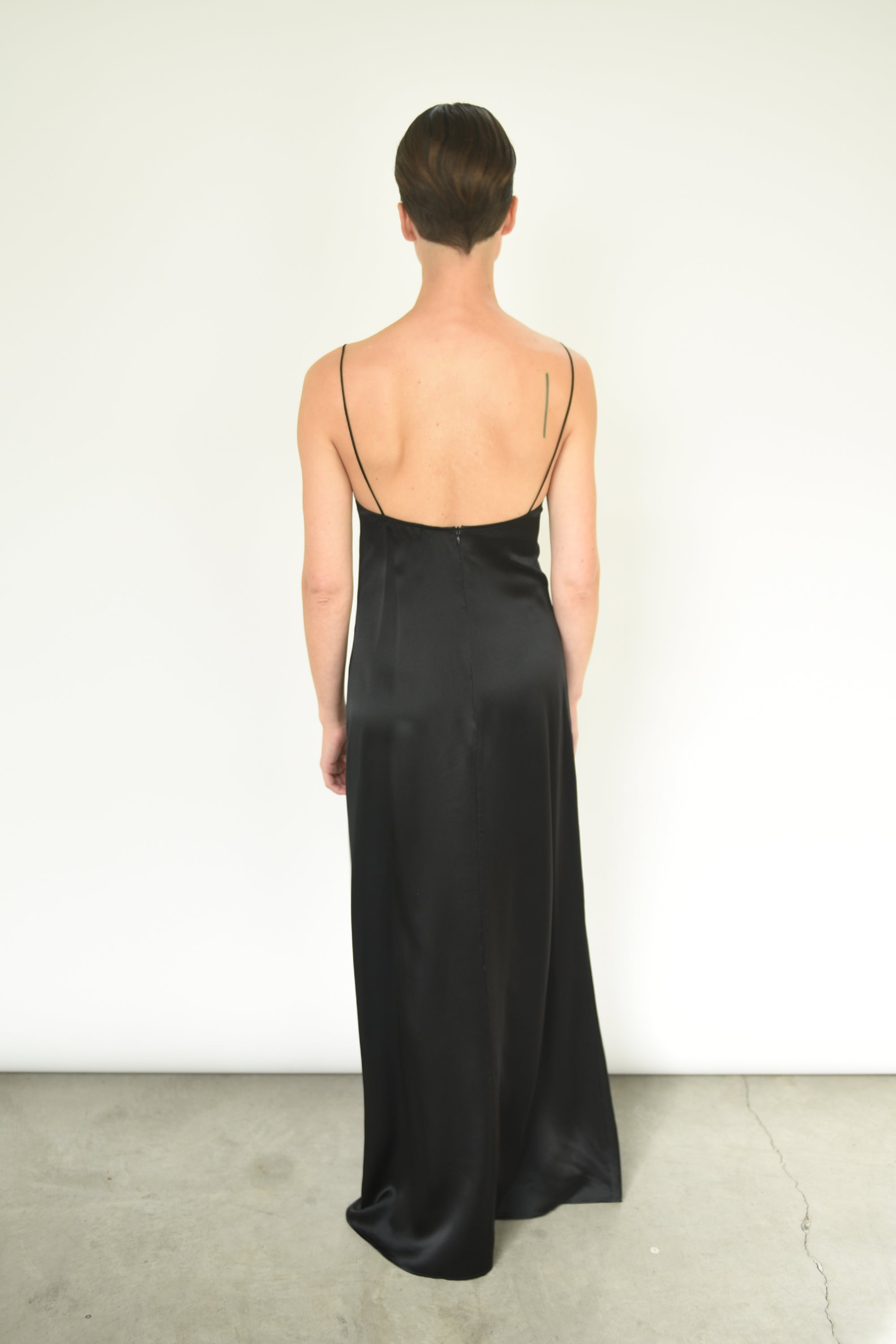 Back view of the black silk charmeuse Kamperett Sloan Slip with invisible zip closure.