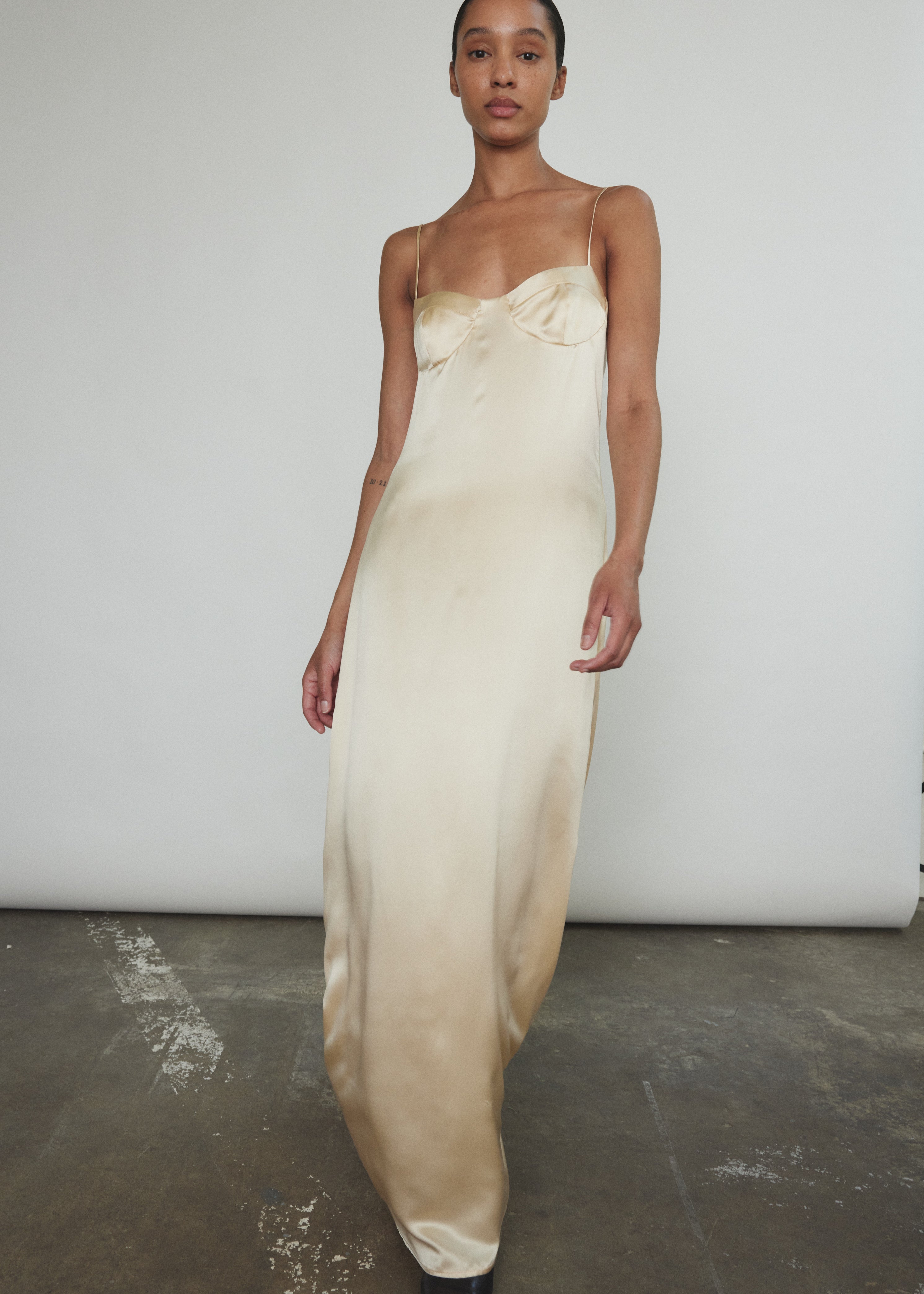 Back view of the champagne silk charmeuse Kamperett Sloan Slip with invisible zip closure.