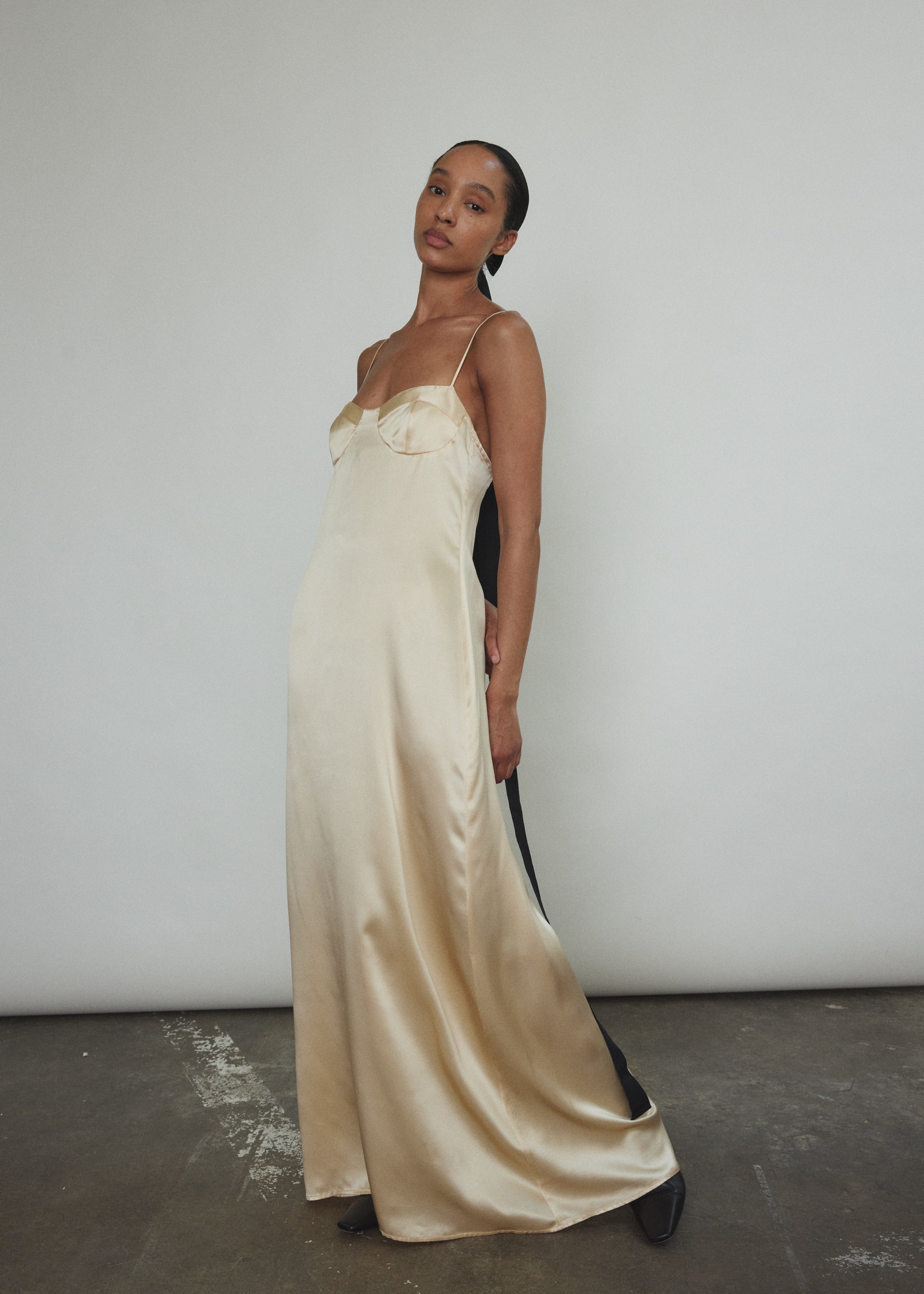 Detail of the corded straps and three-part cup on the champagne silk charmeuse Kamperett Sloan Slip.