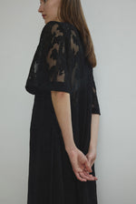 Detail of the eyelash lace hem on the black French lace Kamperett Thea Lace Sheath Dress.