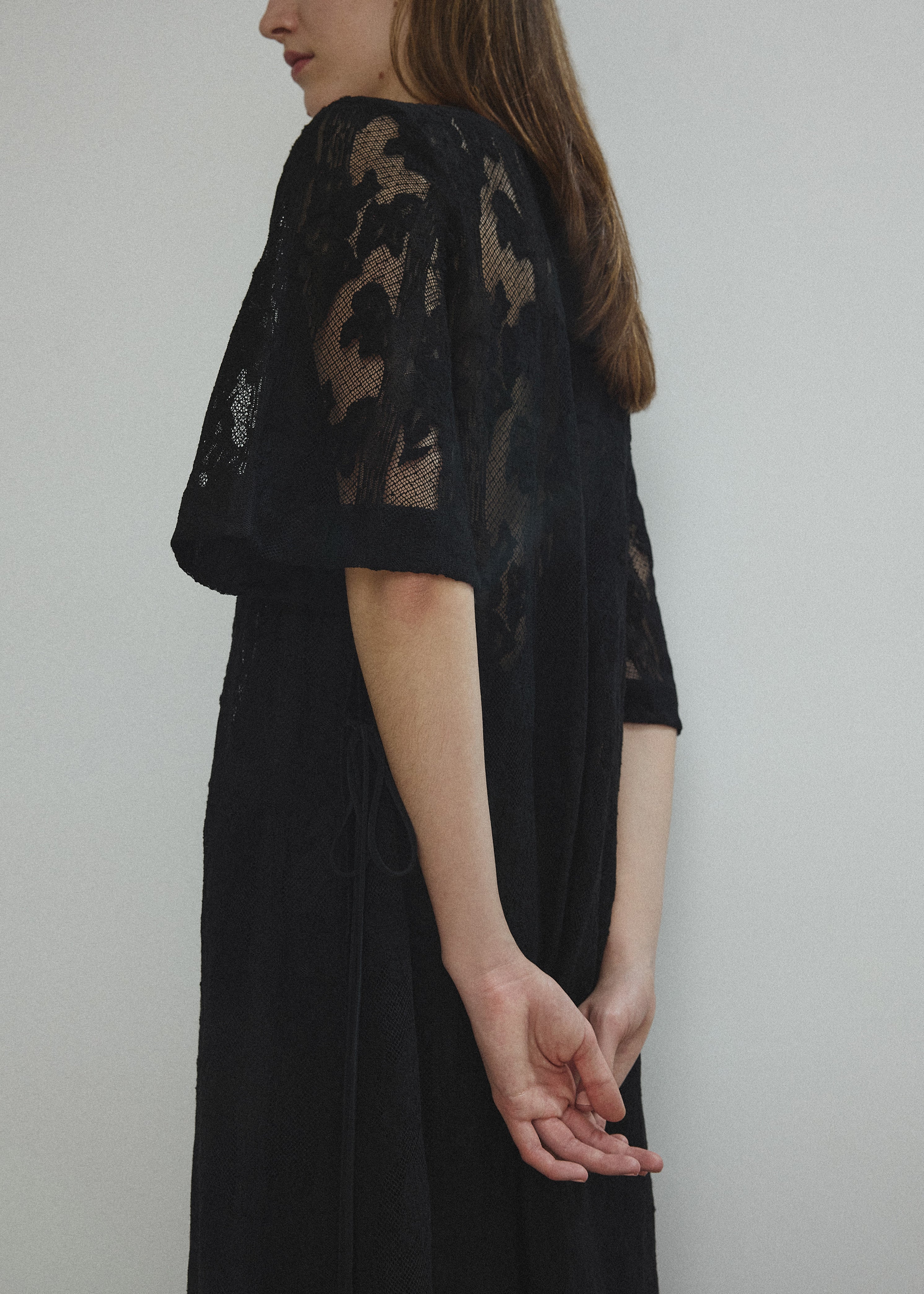Detail of the eyelash lace hem on the black French lace Kamperett Thea Lace Sheath Dress.