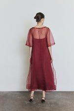 Back view of the bordeaux silk organza Kamperett Thea Sheath Dress showing the straight-cut silhouette.