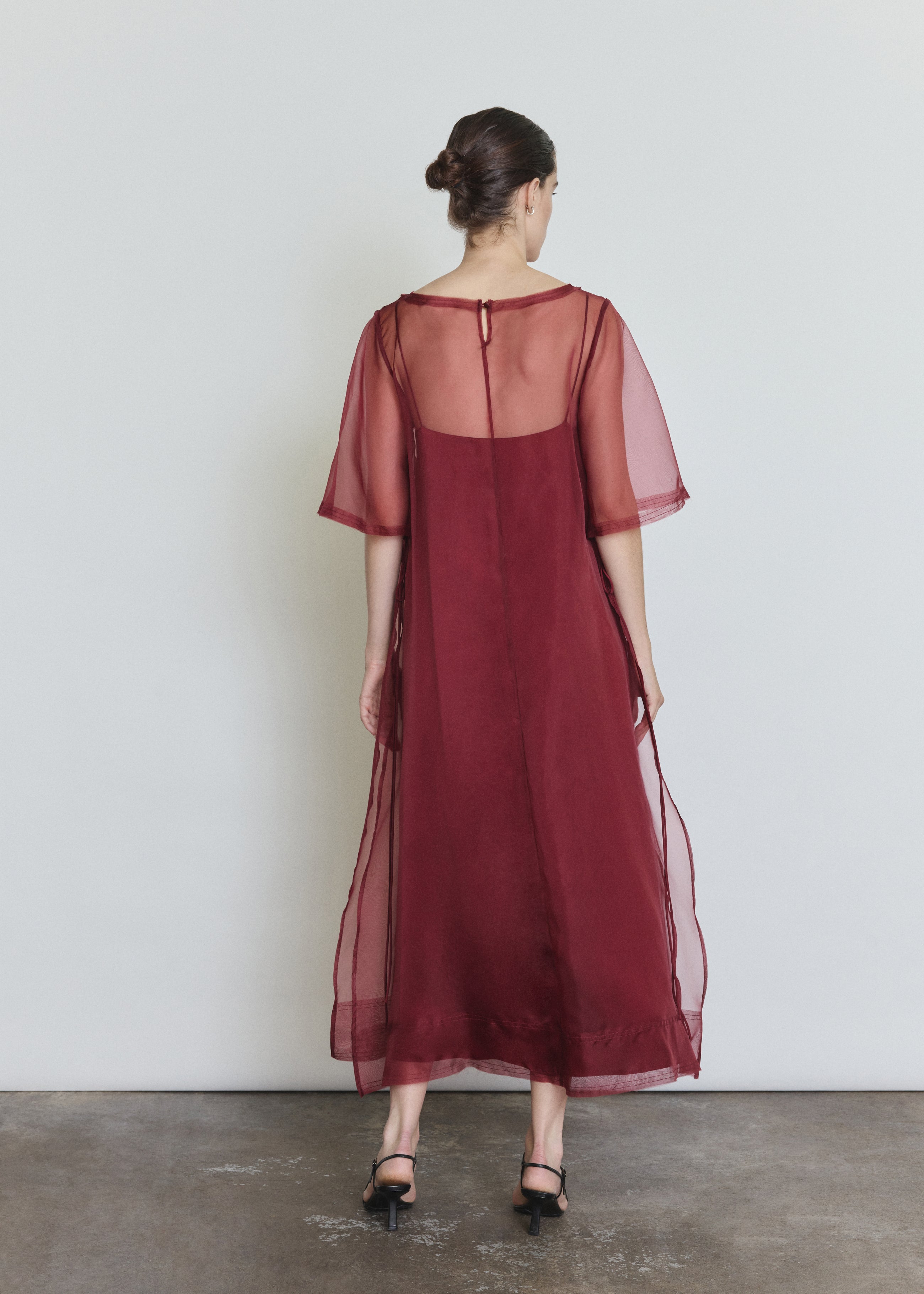 Back view of the bordeaux silk organza Kamperett Thea Sheath Dress showing the straight-cut silhouette.