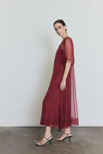 Side view of the bordeaux silk organza Kamperett Thea Sheath Dress showing the open side seams with self corded ties.