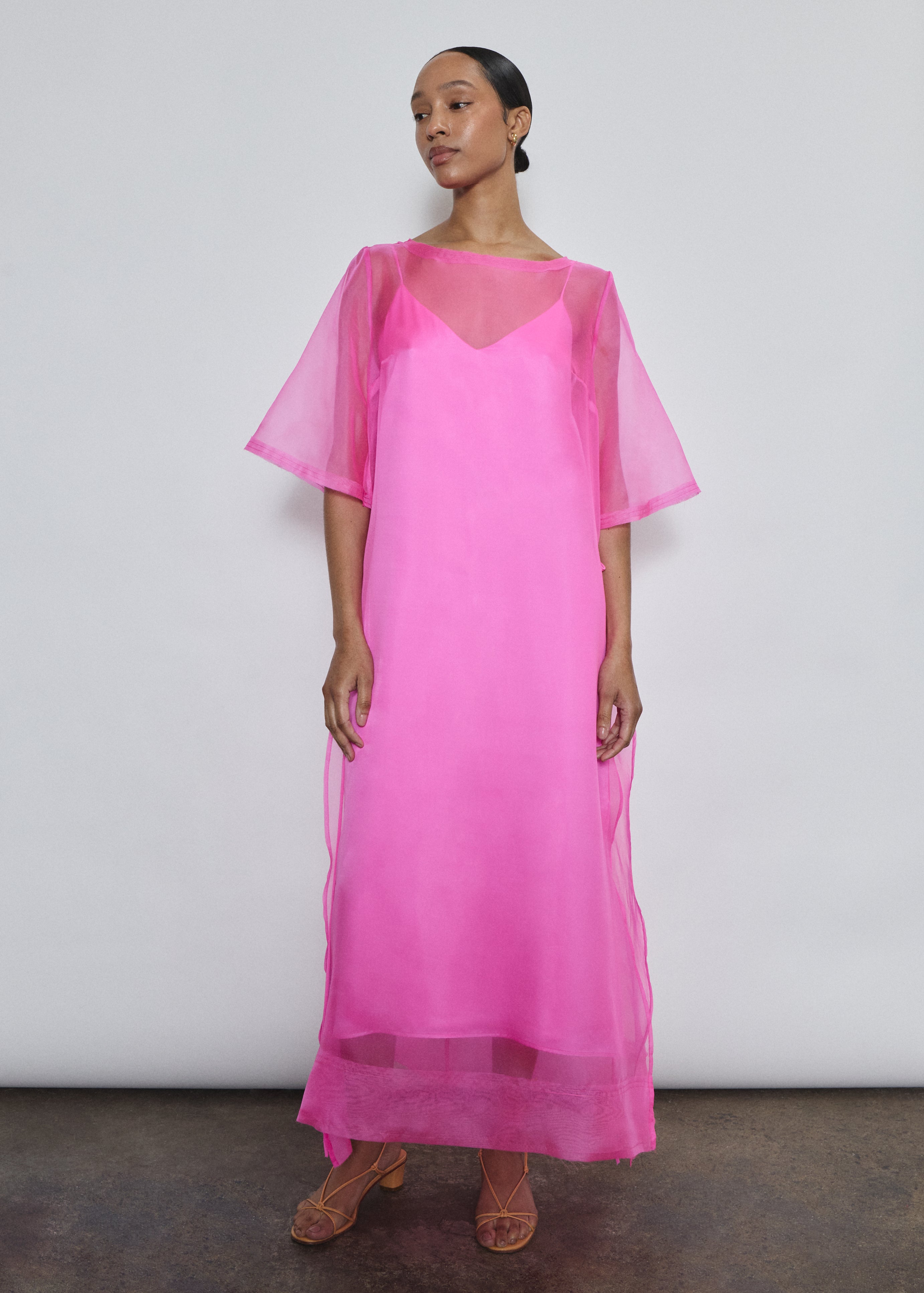Hot pink silk organza midi dress with raw edge neckline and self corded ties. Effortless sheath silhouette in a vivid, luminous hue. Handcrafted in California.