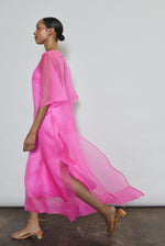 Left profile of hot pink silk organza Thea Sheath Dress. Straight-cut minimalist silhouette glows in saturated silk. Elevated luxury occasion wear, designed in San Francisco.