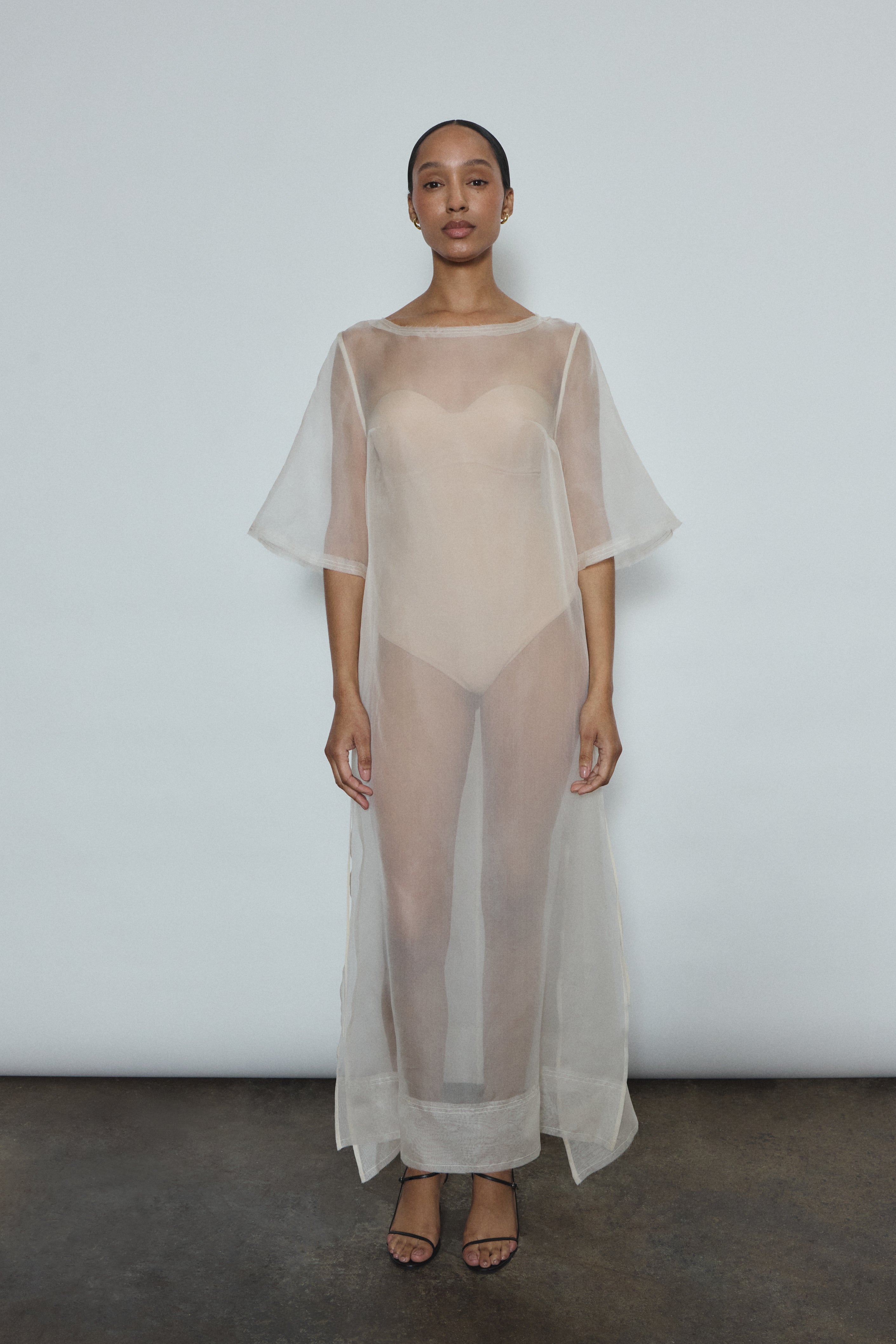 Ivory silk organza midi dress with raw edge neckline and self corded ties. Minimalist sheath silhouette, handcrafted in California. Effortless luxury occasion wear.