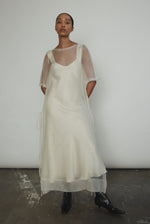 Ivory silk organza midi dress with raw edge neckline and self corded ties. Minimalist sheath silhouette, handcrafted in California. Effortless luxury occasion wear.