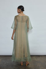 Rear view of jade Thea Sheath Dress in sheer silk organza. Open side seams and wide hem facing show refined construction. Ethically made in California for the discerning woman.