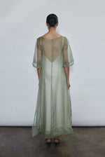 Rear view of jade Thea Sheath Dress in sheer silk organza. Open side seams and wide hem facing show refined construction. Ethically made in California for the discerning woman.