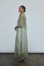 Left profile of jade silk organza Thea Sheath Dress. Straight-cut minimalist silhouette, cool to the touch and luminous in motion. Designed in San Francisco.
