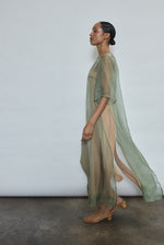 Left profile of jade silk organza Thea Sheath Dress. Straight-cut minimalist silhouette, cool to the touch and luminous in motion. Designed in San Francisco.