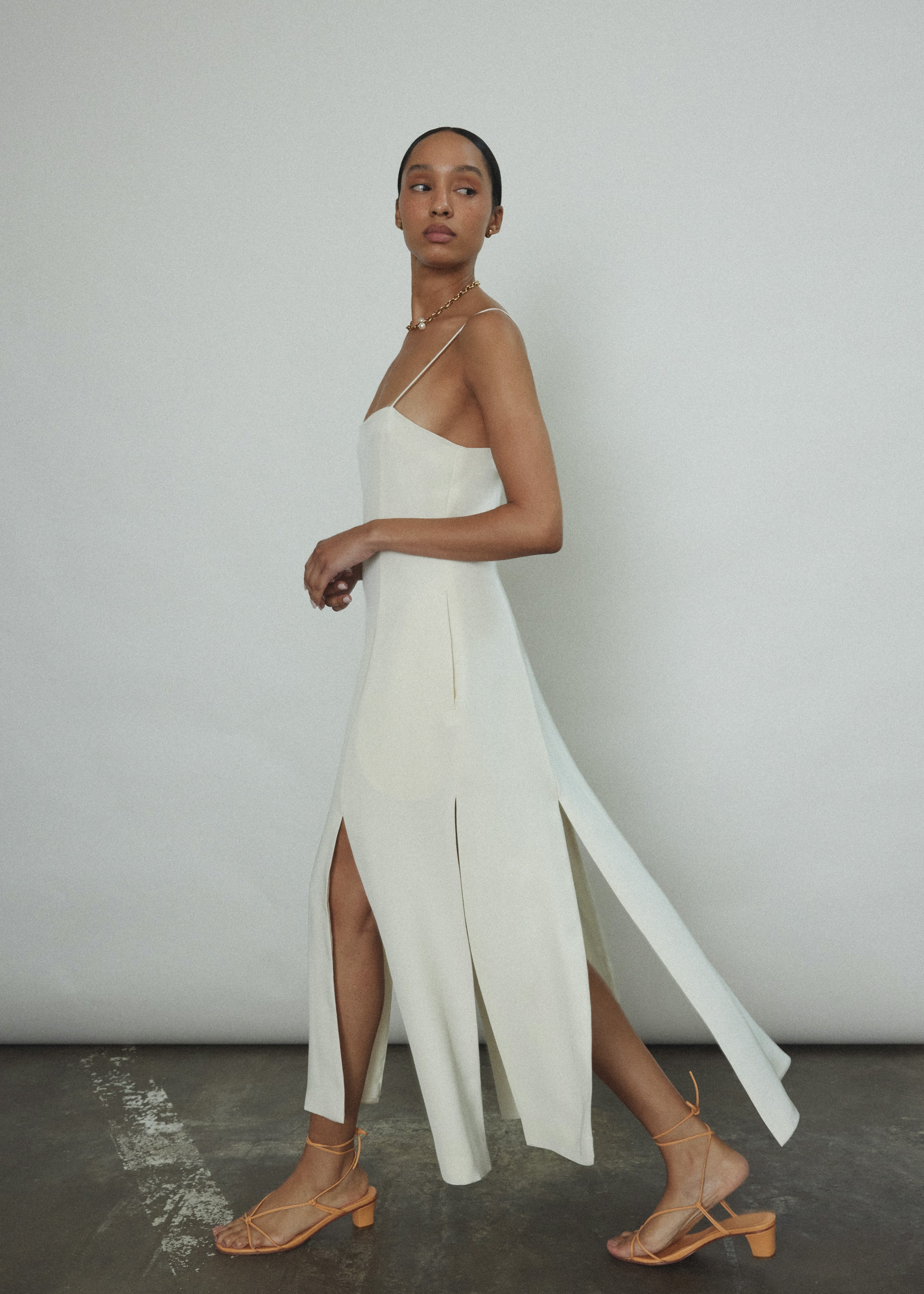 Editorial image of the alabaster silk crepe Kamperett Theodora Dress.