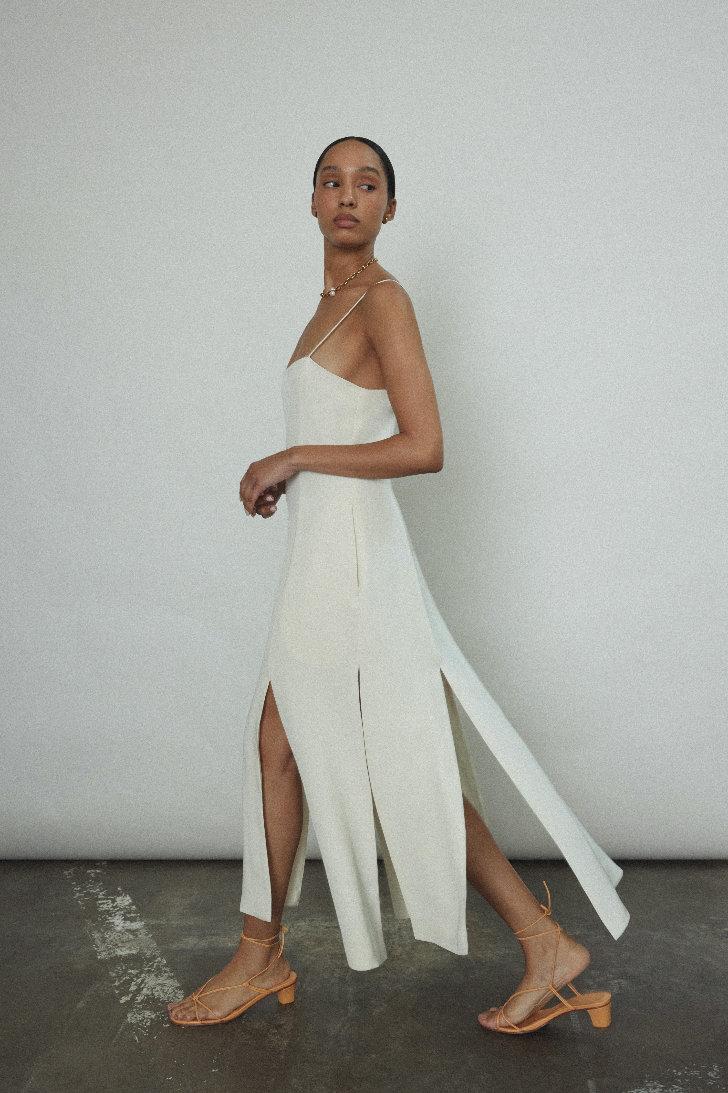 Editorial image of the alabaster silk crepe Kamperett Theodora Dress.