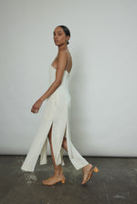 Editorial portrait of a bride in the alabaster silk crepe Kamperett Theodora Dress.