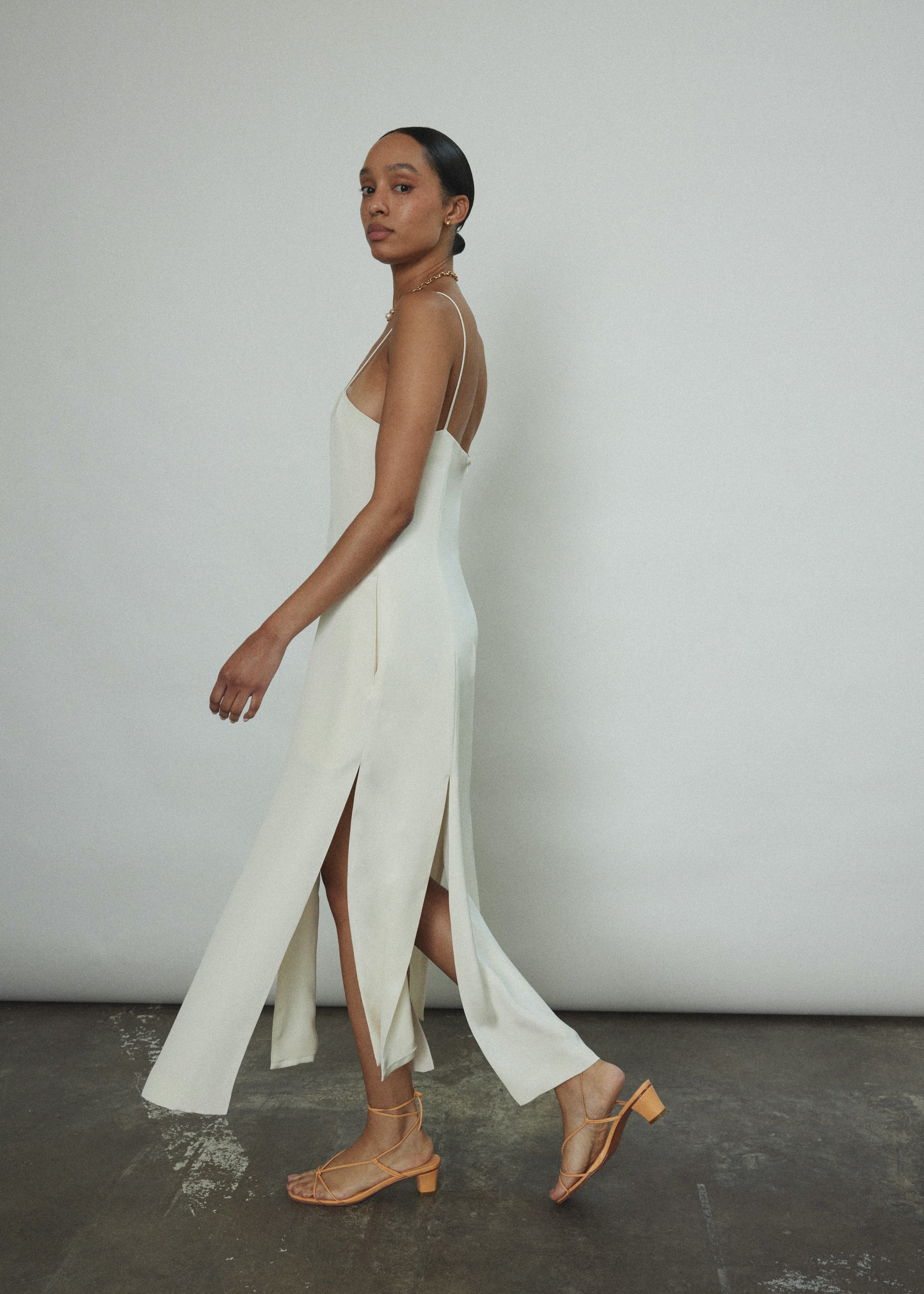 Editorial portrait of a bride in the alabaster silk crepe Kamperett Theodora Dress.