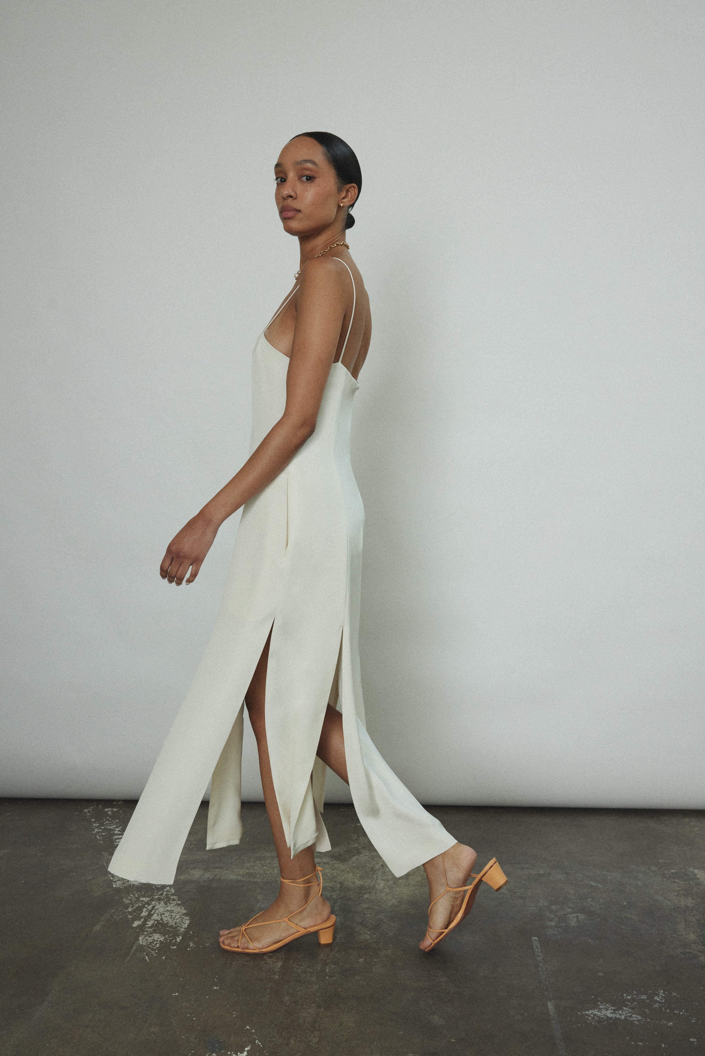 Editorial portrait of a bride in the alabaster silk crepe Kamperett Theodora Dress.