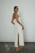 Editorial image of a bride wearing the alabaster silk crepe Kamperett Theodora Dress.