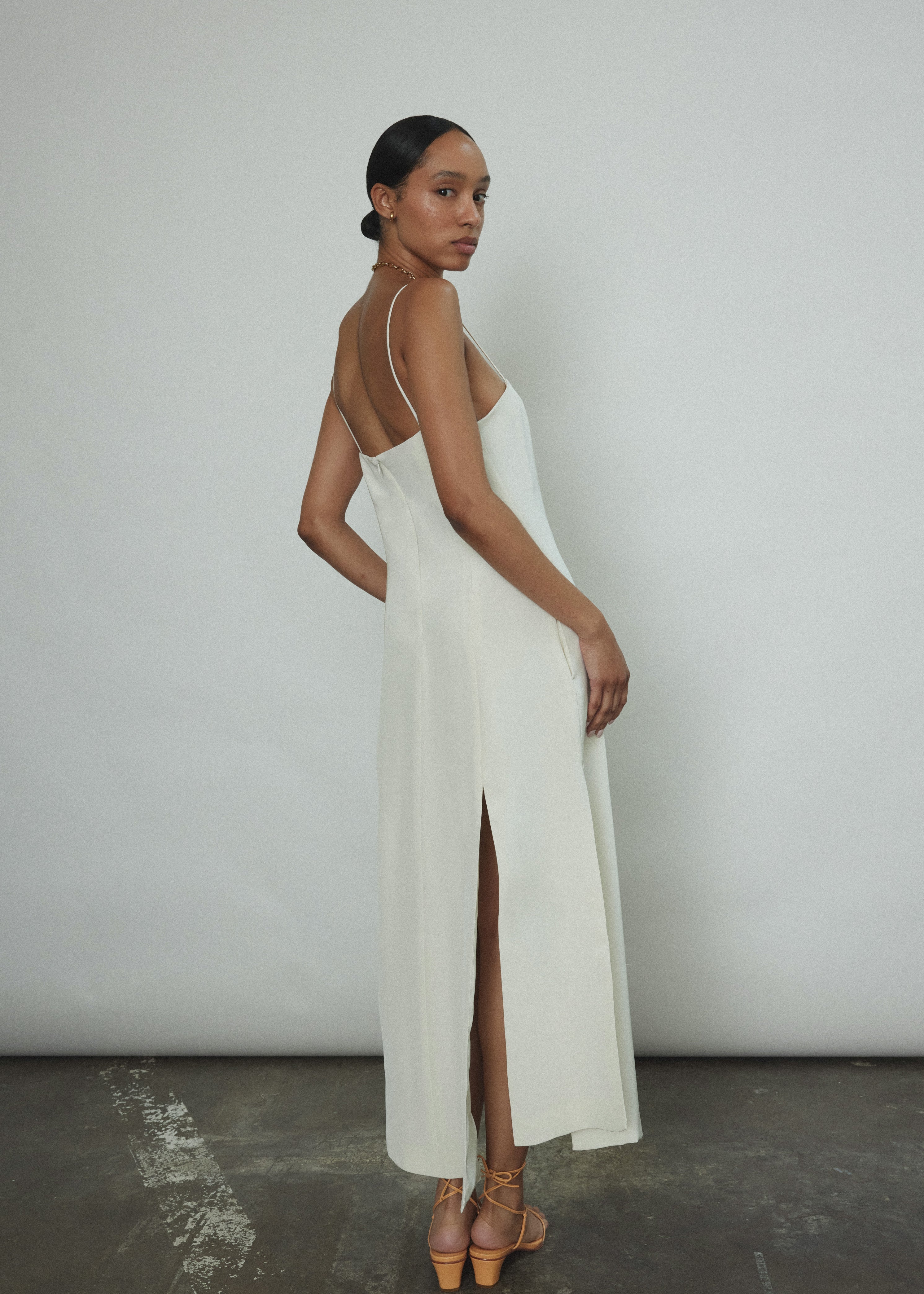 Editorial image of a bride wearing the alabaster silk crepe Kamperett Theodora Dress.