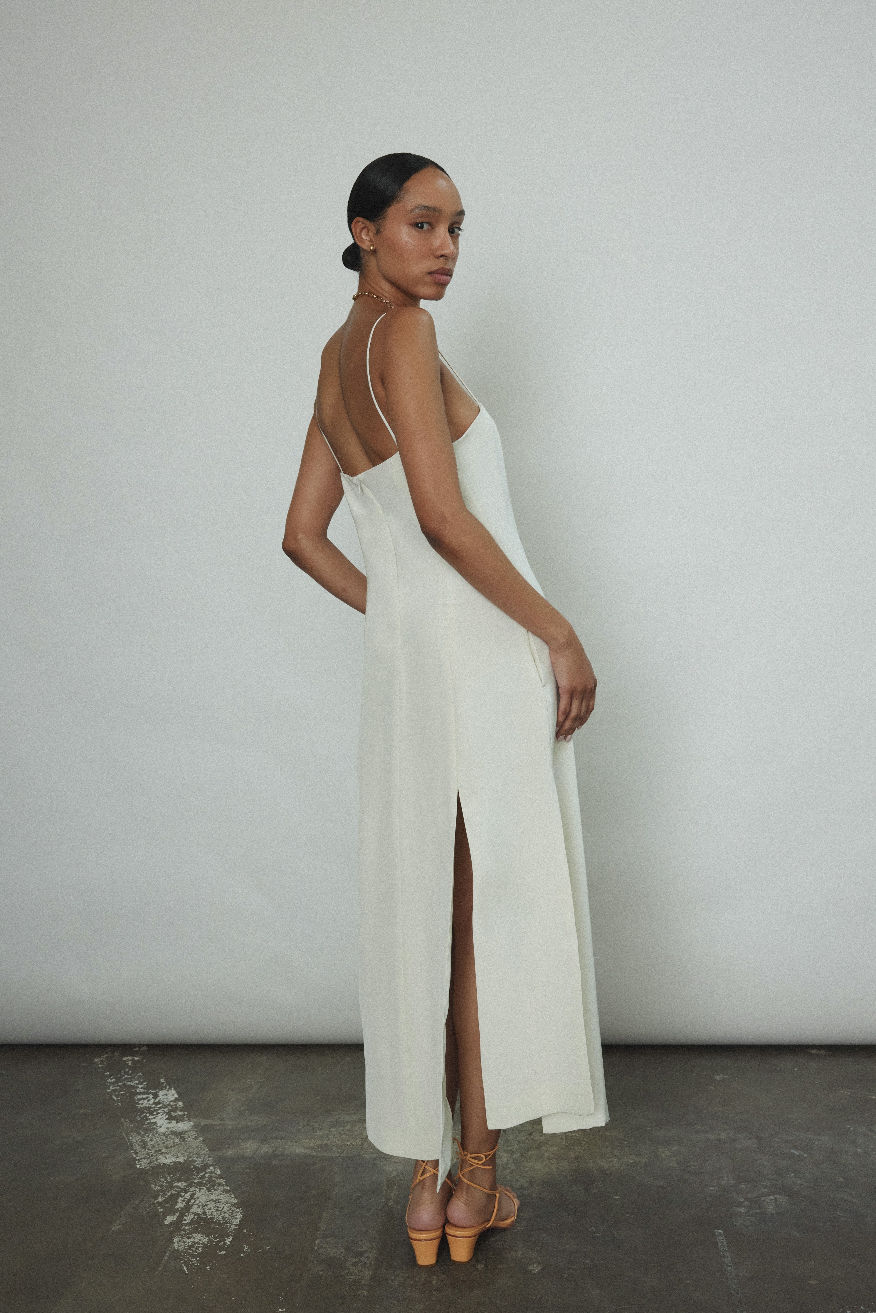 Editorial image of a bride wearing the alabaster silk crepe Kamperett Theodora Dress.