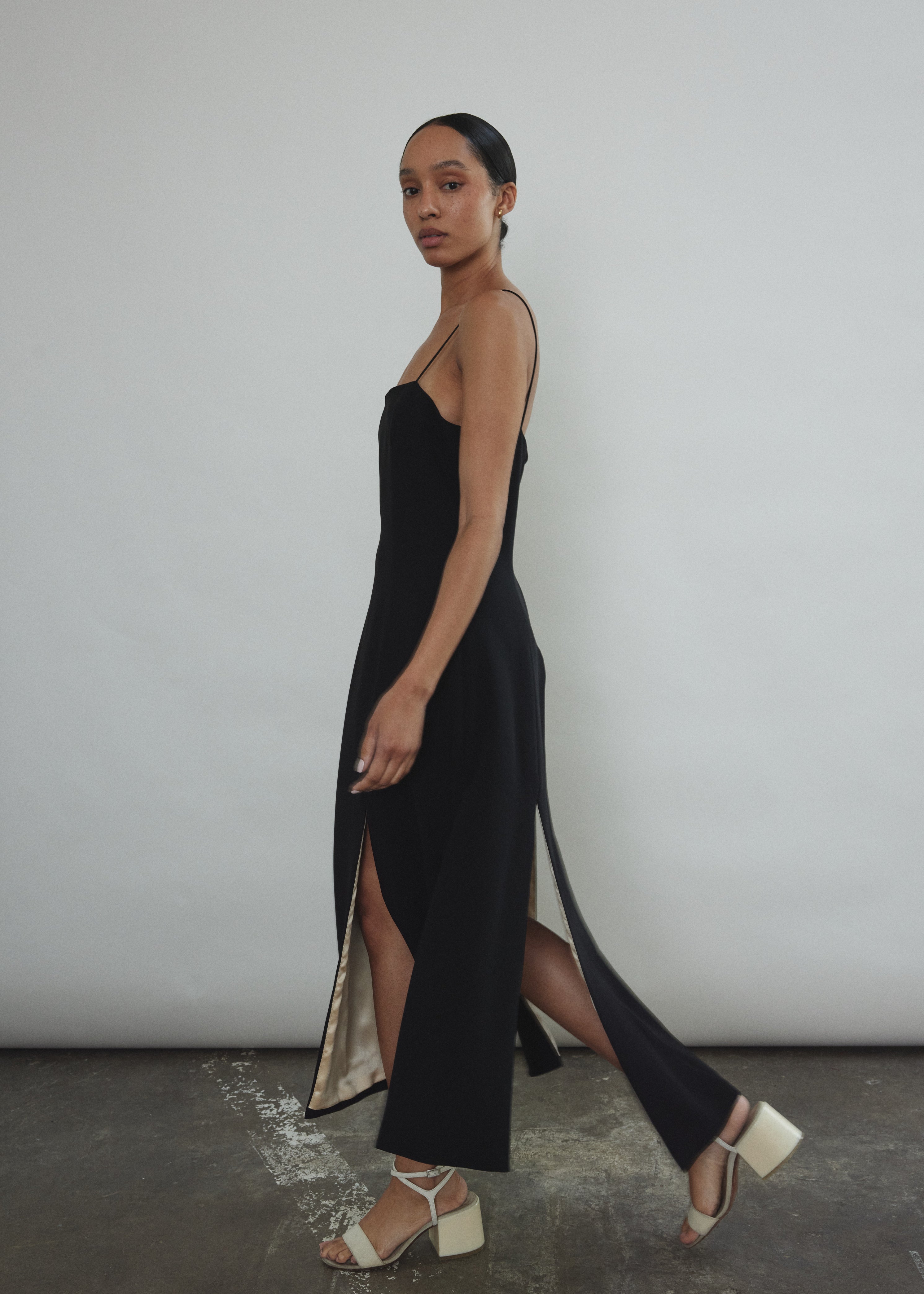 Editorial image of the black crepe Kamperett Theodora Dress with silk charmeuse lining.