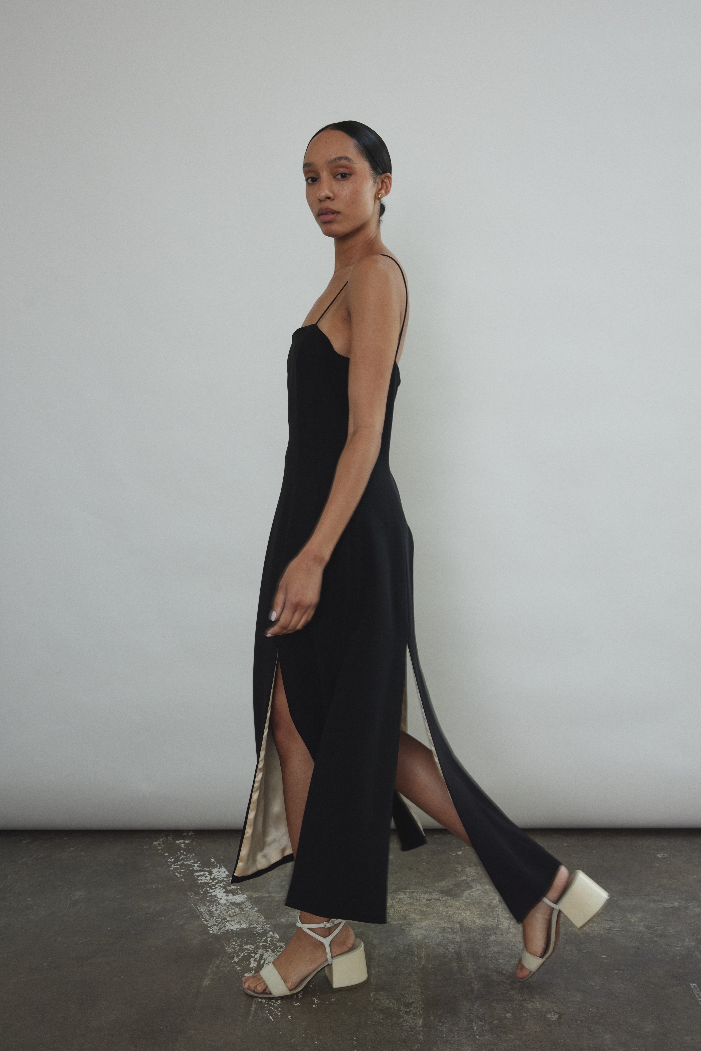 Editorial image of the black crepe Kamperett Theodora Dress with silk charmeuse lining.
