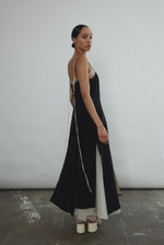 Detail of the multi-slit hemline on the black crepe Kamperett Theodora Dress.