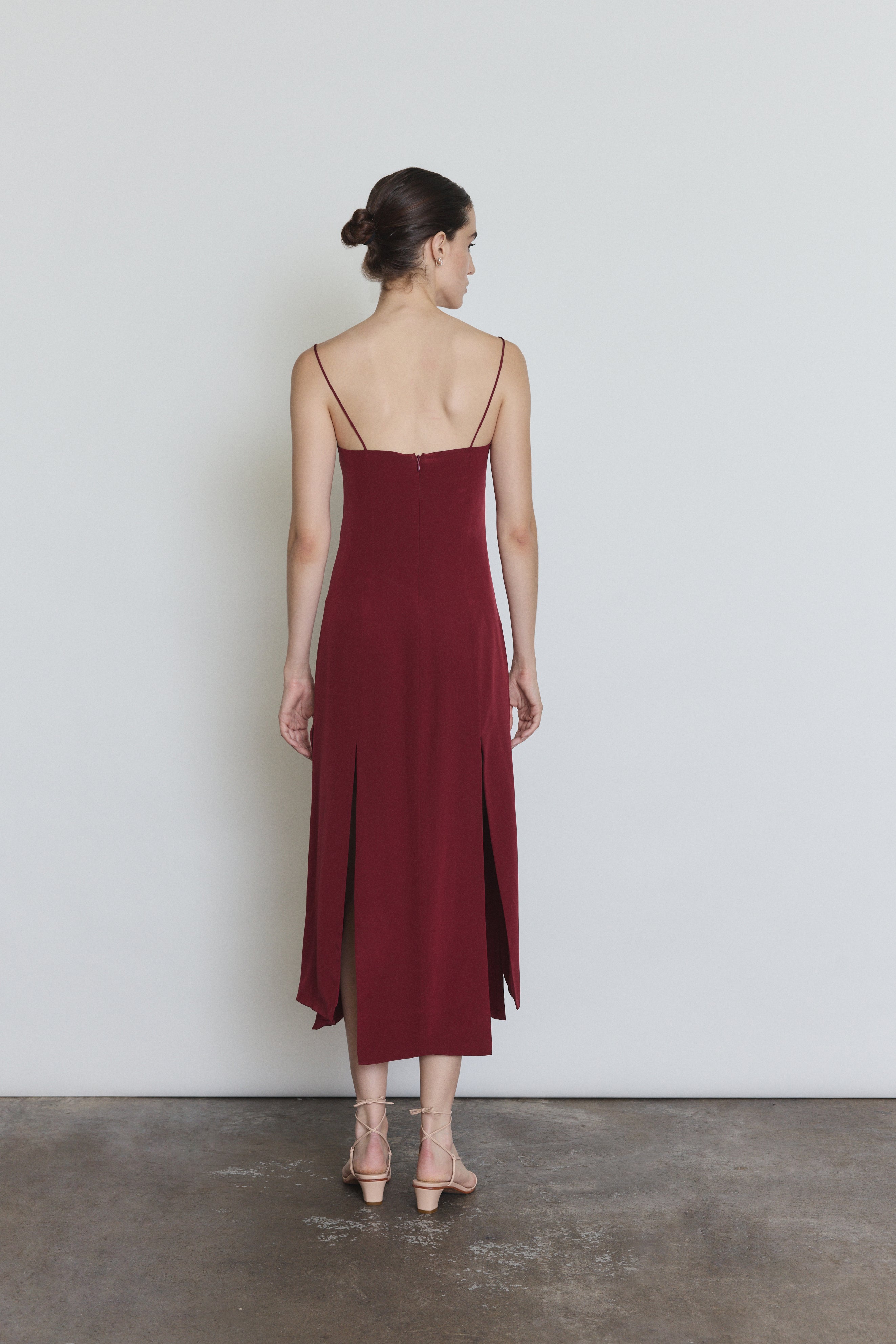 Back view of the bordeaux silk Kamperett Theodora Dress showing the corded straps.
