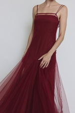 Editorial image of the bordeaux Kamperett Theodora Dress layered under the Camille Dress in Bordeaux.