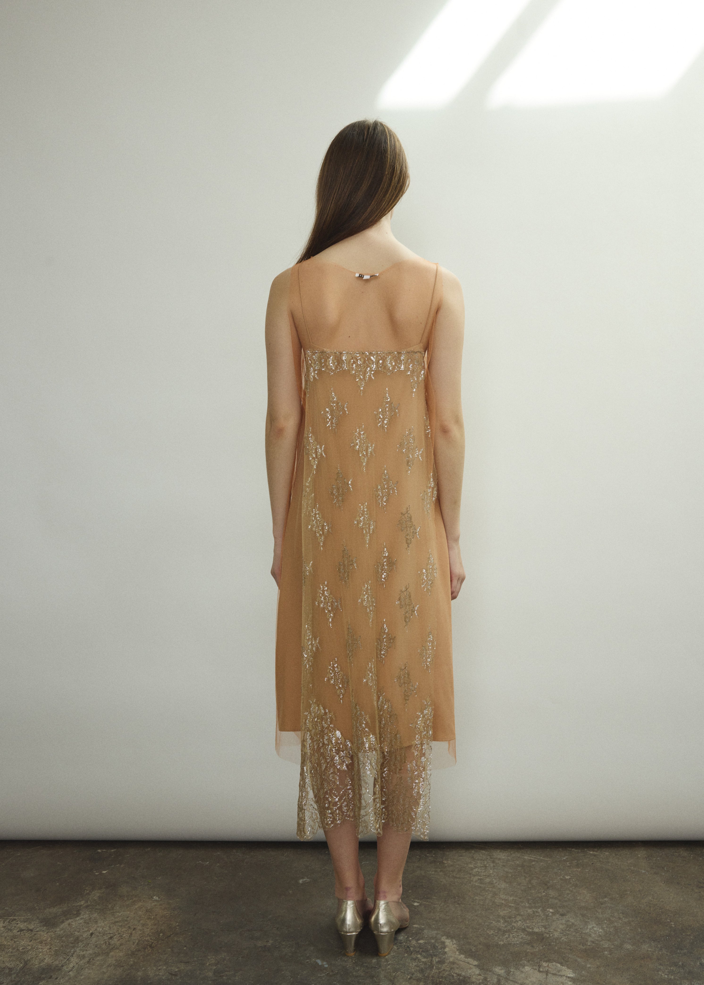 Rear view of Kamperett Thistle Lace Shift — French lace appliqué panel at back, clean unlined construction, architectural A-line hem. Handcrafted in California.