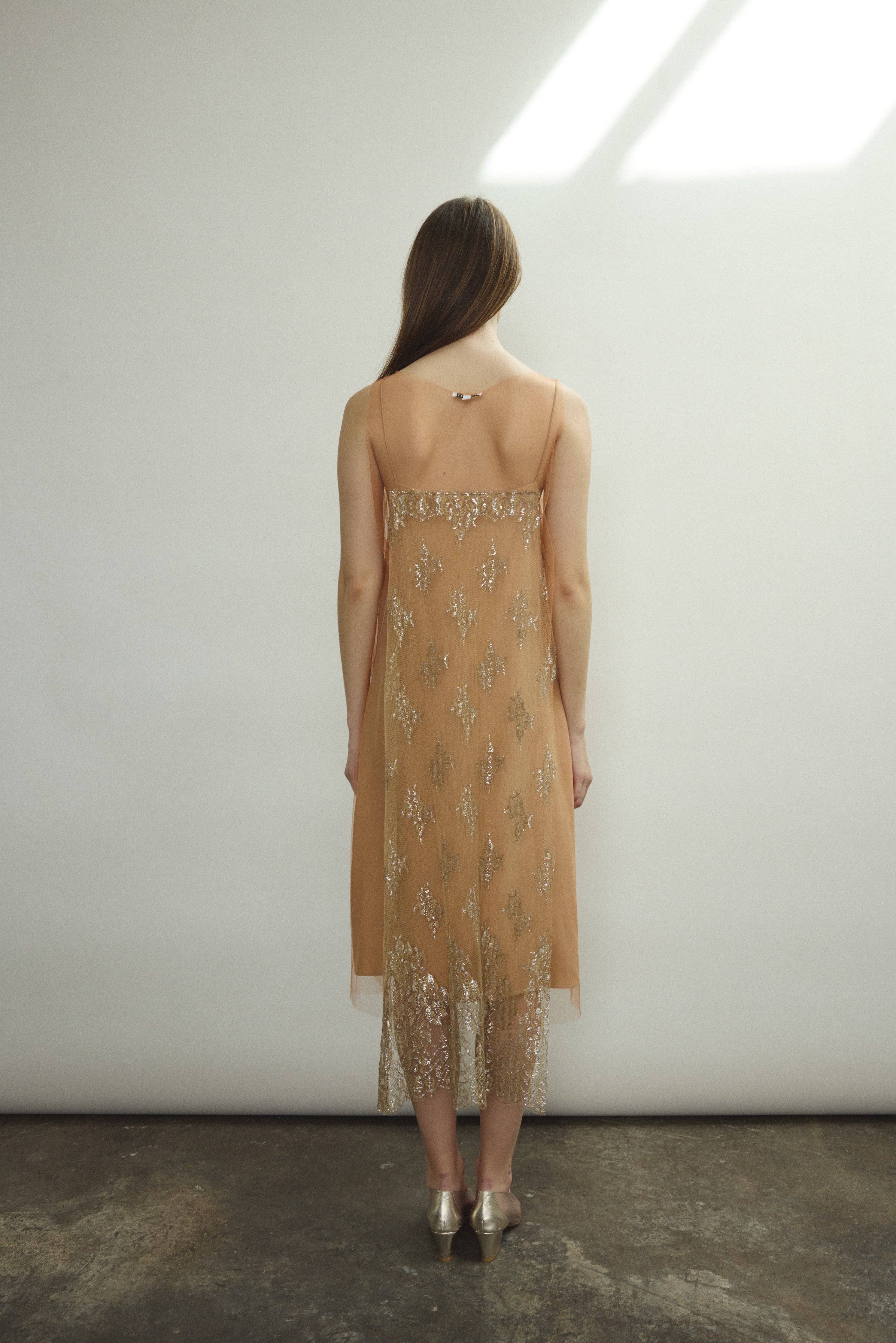 Rear view of Kamperett Thistle Lace Shift — French lace appliqué panel at back, clean unlined construction, architectural A-line hem. Handcrafted in California.