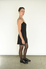 Angled view of the black silk Kamperett V-Neck Mini Slip.